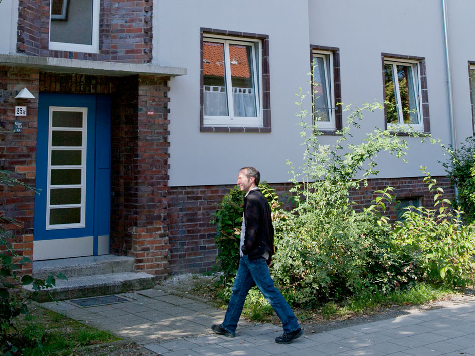 Ein Mann geht auf dem Bürgersteig entlang.