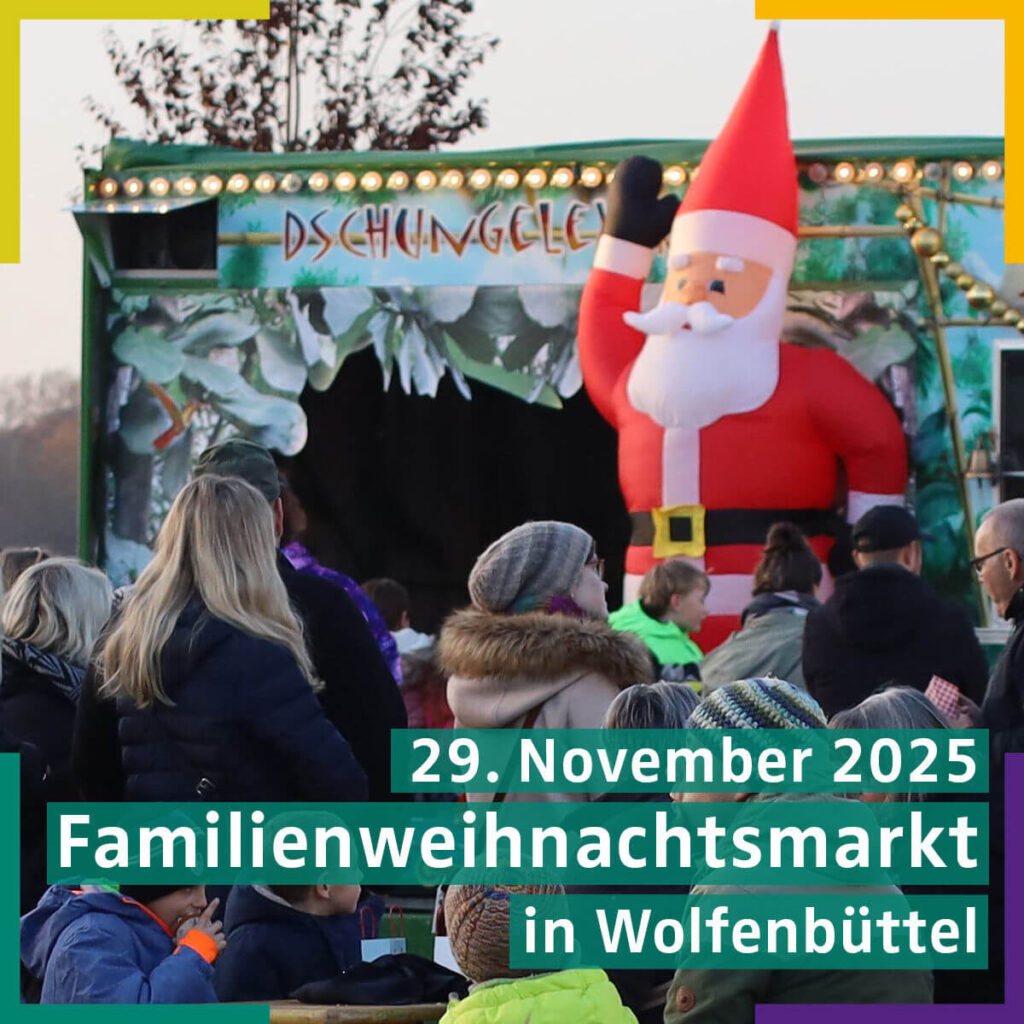 Familienweihnachtsmarkt in Wolfsburg mit festlich geschmückten Ständen und fröhlichen Besuchern in winterlicher Atmosphäre.